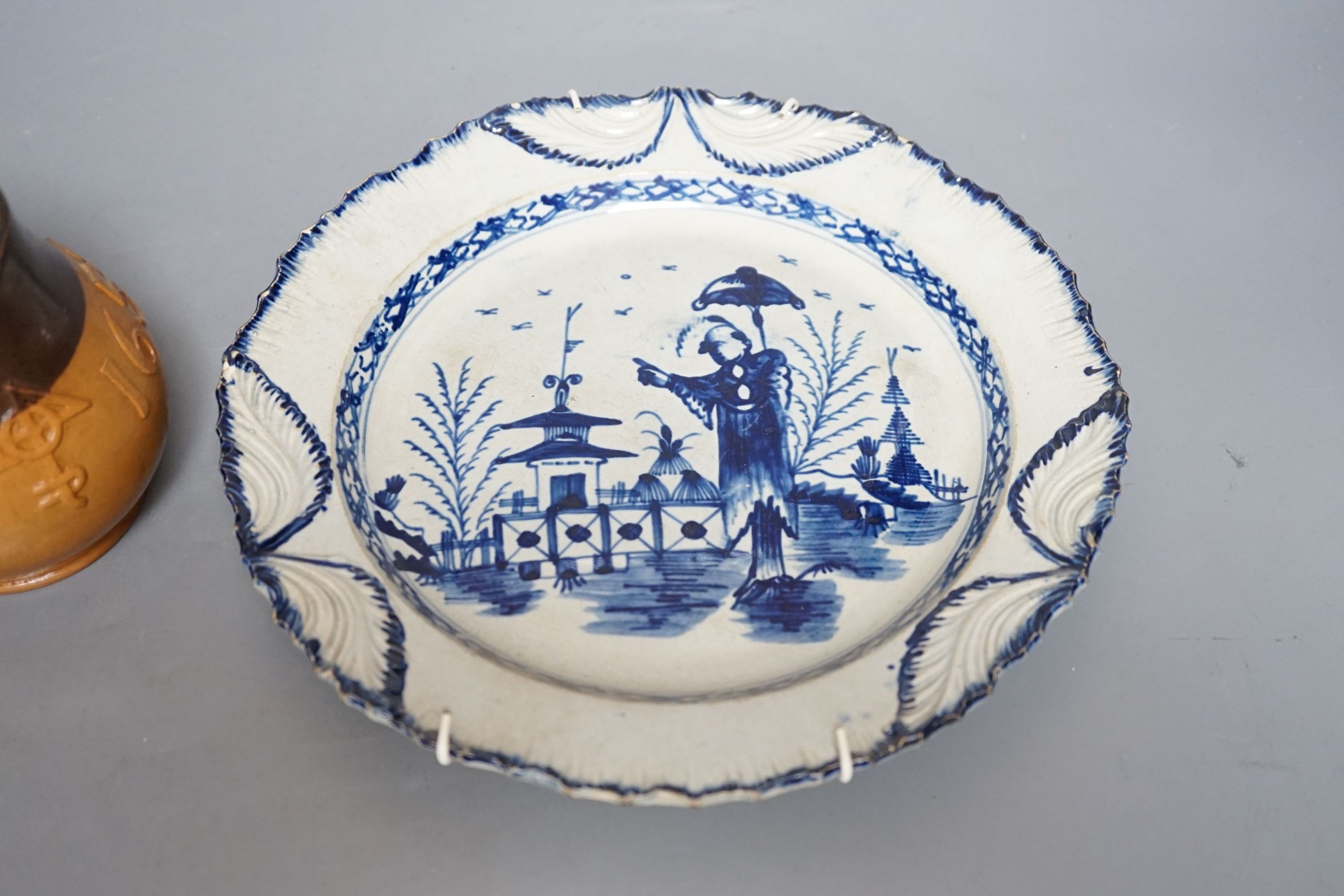 An early 19th century English pearlware plate and a Doulton Salisbury Gill jug, 11cm tall